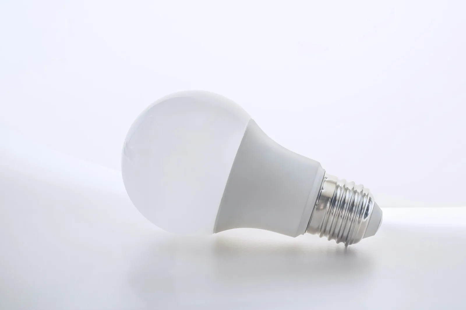 A white LED light bulb on a white table