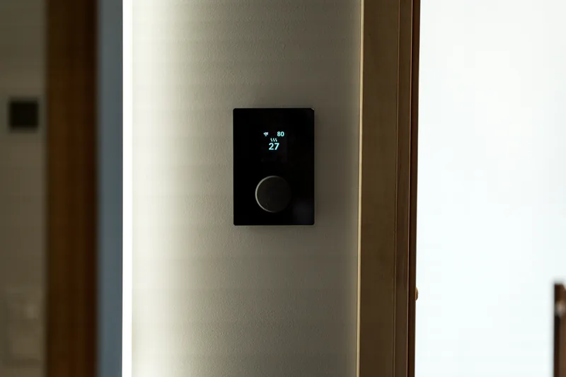 Modern black wall-mounted thermostat