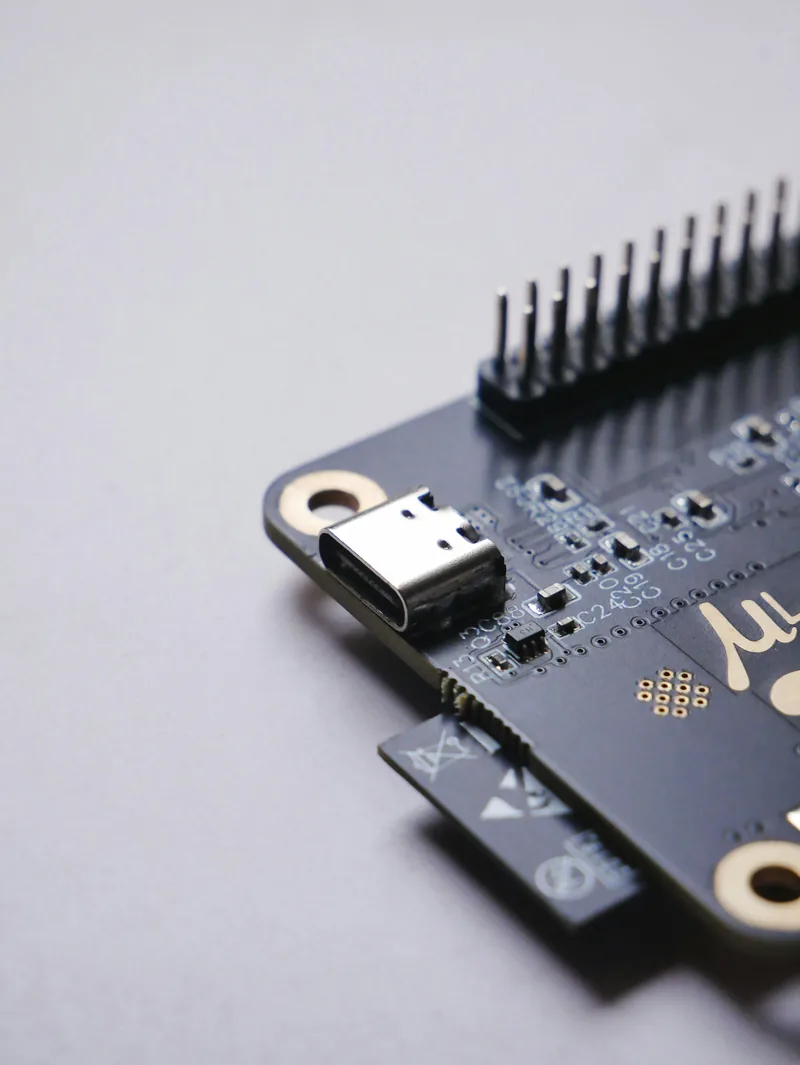 Small microcontroller board with a USB cable attached