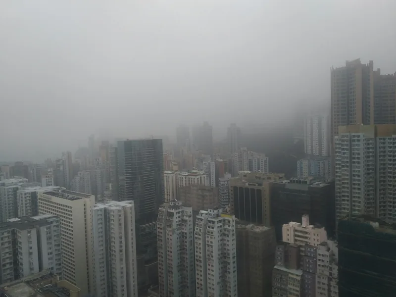 City high-rises disappearing into thick fog