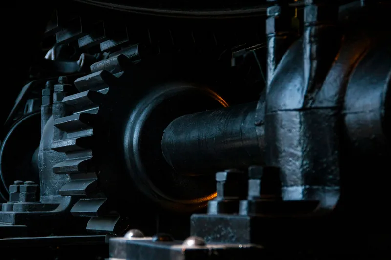 Close-up of black metal gears on an industrial machine