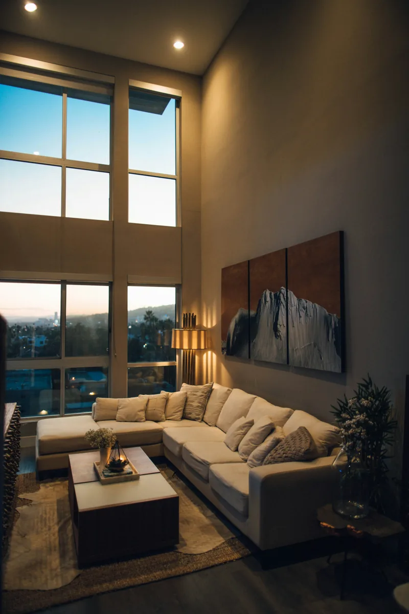 Grey couch beside a window in a quiet living room