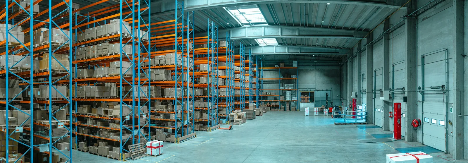 Tall blue warehouse racks filled with cardboard boxes
