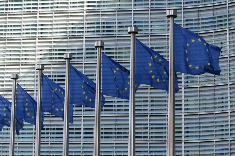 Row of European Union flags outside a building