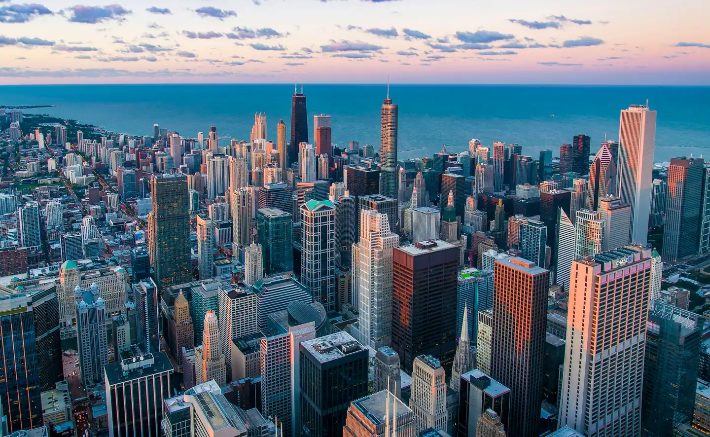 Aerial view of a dense city skyline by a lake