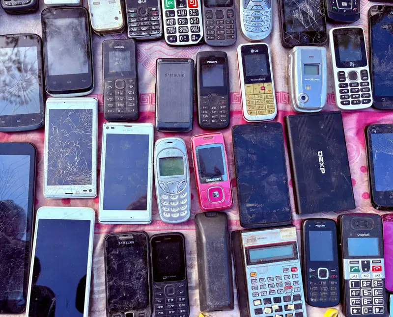 A collection of old mobile phones and devices