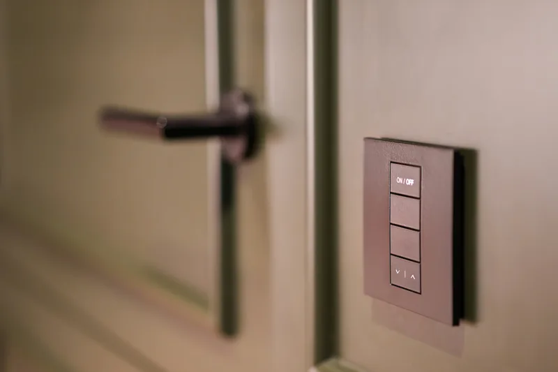 A smart wall keypad next to a door handle